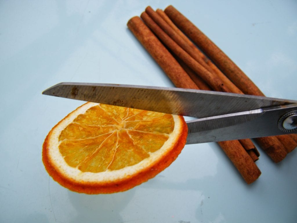 cutting dried oranges for Christmas scented bags