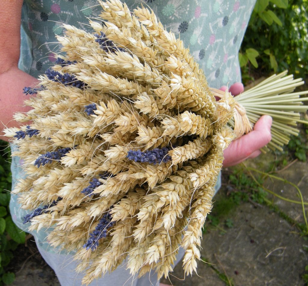 holding wheat lavender bouquet