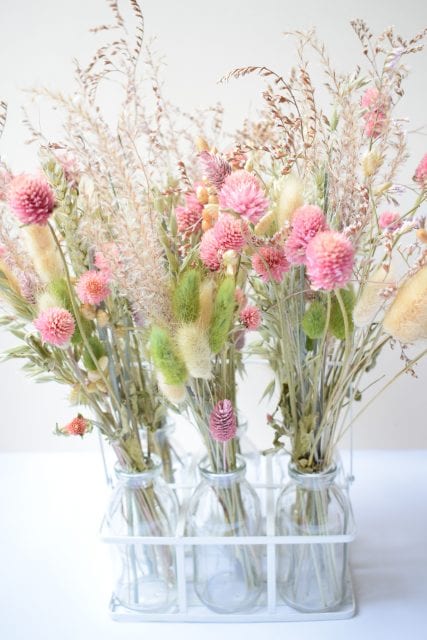 pink dried flowers grasses milk bottles